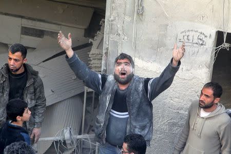 A man reacts for the loss of family members after an air strike on the rebel held al-Saliheen district in Aleppo, Syria, March 11, 2016. REUTERS/Abdalrhman Ismail