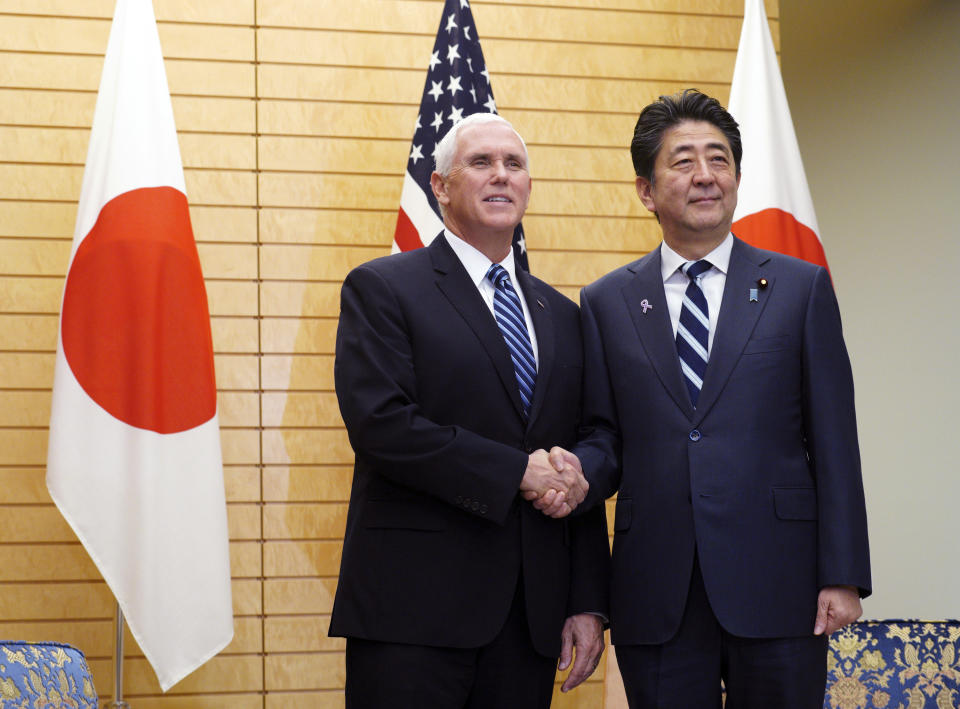 U.S. Vice President Mike Pence, left, shakes hands with Japanese Prime Minister Shinzo Abe at Abe's official residence in Tokyo Tuesday, Nov. 13, 2018. (AP Photo/Eugene Hoshiko)