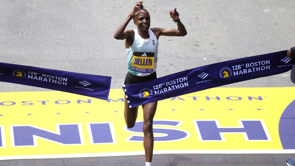 Hellen Obiri, of Kenya, raises her arms as she wins the women's division at the Boston Marathon, Monday, April 15, 2024, in Boston. / Credit: Charles Krupa / AP