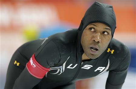 Shani Davis of the U.S. looks at his time after competing in the men's 1,000 meters speed skating race during the 2014 Sochi Winter Olympics, February 12, 2014. REUTERS/Phil Noble