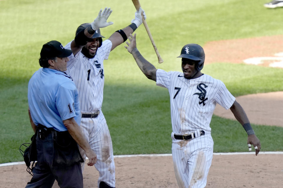 After stealing third, Chicago White Sox's Tim Anderson scores the game winning run in the 10th inning on a throwing error by Seattle Mariners shortstop J.P. Crawford as Elvis Andrus and home plate umpire Phil Cuzzi watch in a baseball game Wednesday, Aug. 23, 2023, in Chicago. The White Sox won 5-4. (AP Photo/Charles Rex Arbogast)