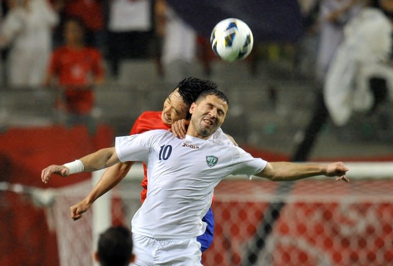 South Korea's Kwak Tae-Hwi (back) fight for the ball with Uzbekistan's Bakaev Ulugbek, during their 2014 FIFA World Cup Asian qualifier, in Seoul, on June 11, 2013. Uzbekistan will seek atonement for a notorious incident which remains one of the dark episodes of Asian football when they head into a crunch World Cup play-off against Jordan on Friday