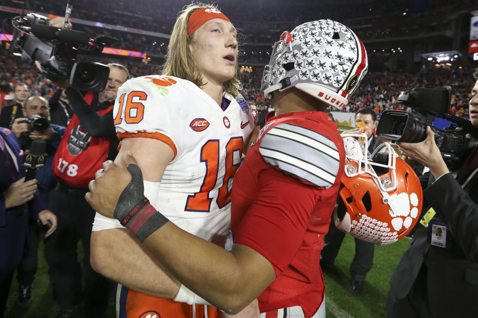 Clemson quarterback Trevor Lawrence, left, and Ohio State quarterback Justin Fields meet after the Fiesta Bowl NCAA college football playoff semifinal Saturday, Dec. 28, 2019, in Glendale, Ariz. (AP Photo/Ross D. Franklin)