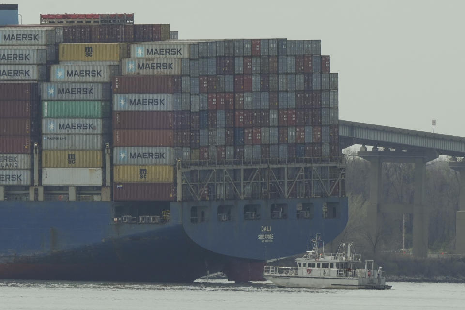 A container ship rests against wreckage of the Francis Scott Key Bridge on Tuesday, March 26, 2024, as seen from Dundalk, Md. The ship rammed into the major bridge in Baltimore early Tuesday, causing it to collapse in a matter of seconds and creating a terrifying scene as several vehicles plunged into the chilly river below. (AP Photo/Matt Rourke)