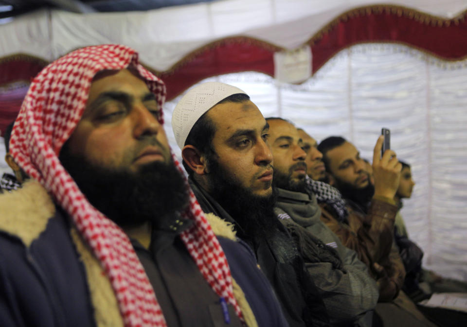 In this Thursday, Jan. 9, 2014 photo, Egyptian Salafis listen toa lecture entitled “Know Your Constitution," ahead of a two-day vote on a draft amendment in El-Saf village, 50 kilometers (31 miles) south of Cairo, Egypt. The conference, held to rally “yes” votes for the charter, highlights a striking alliance that has emerged since the military toppled Islamist President Mohammed Morsi and his democratically elected government last summer. Both the military-backed authorities and the Al-Nour party appear to be benefiting from it, despite the awkwardness. (AP Photo/Amr Nabil)