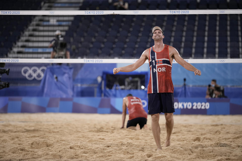 Anders Berntsen Mol, right, of Norway, and teammate Christian Sandlie Sorum, celebrate winning a men's beach volleyball semifinal match against Latvia at the 2020 Summer Olympics, Thursday, Aug. 5, 2021, in Tokyo, Japan. (AP Photo/Felipe Dana)