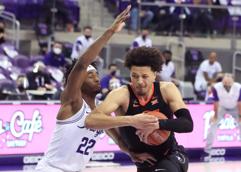 Oklahoma State's Cade Cunningham drives to the basket as TCU's RJ Nembhard defends Feb. 3, 2021 in Fort Worth, Texas.