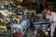 A worker repairs generators at his shop in Basra, Iraq, Tuesday, July 29, 2021. In Iraq, electricity is a potent symbol of endemic corruption, rooted in the country’s sectarian power-sharing system. This contributes to chronic electrical outages of up to 14 hours a day in a major oil-producing nation with plentiful energy resources. (AP Photo/Nabil al-Jurani)