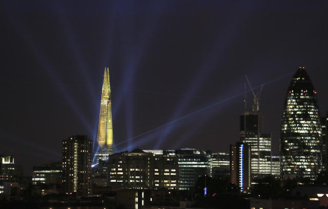 A laser beam touches the Gherkin from the Shard during the laser and searchlight show which marks the completion of the exterior of the Shard building in central London July 5, 2012. The 310-metre (1,016-feet) building, the tallest in western Europe, fired 12 lasers and 30 searchlights from the top of the Shard to 15 London skyscrapers including the Gherkin and the Canary Wharf. REUTERS/Olivia Harris (BRITAIN - Tags: SOCIETY BUSINESS CONSTRUCTION CITYSPACE)