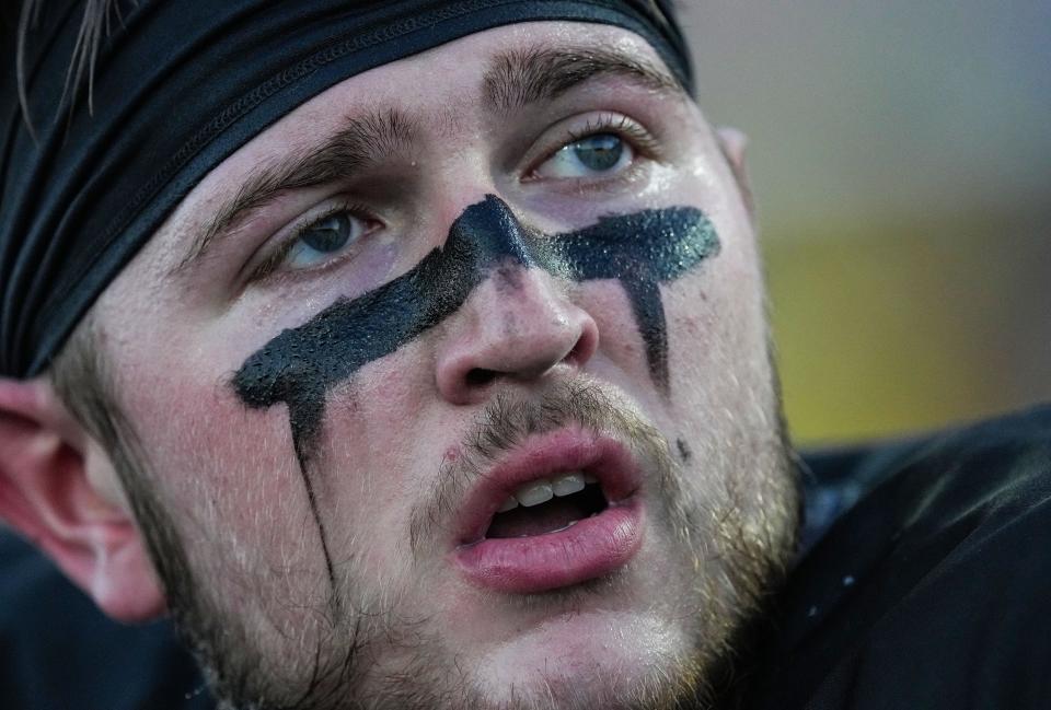 Noblesville Millers tackle Ransom Mcdermott (77) sits on the sidelines Friday, Sept. 1, 2023, during the game at Noblesville High School in Noblesville. The Fishers Tigers defeated the Noblesville Millers, 48-22.