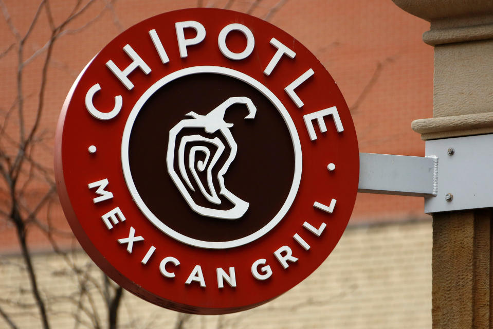 FILE- This Jan. 12, 2017, file photo shows the sign on a Chipotle restaurant in Pittsburgh.  Chipotle is moving its headquarters from its hometown of Denver to southern California, the burrito chain announced Wednesday, May 23, 2018. (AP Photo/Gene J. Puskar, File)