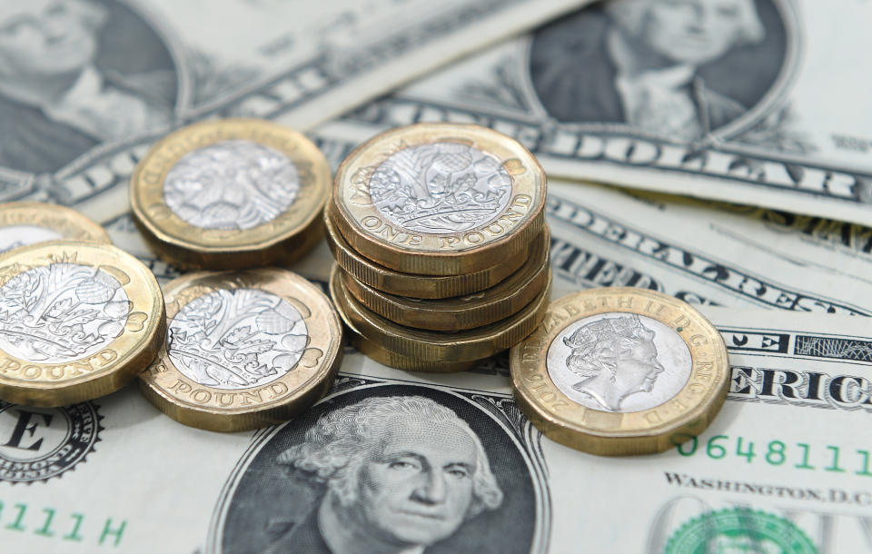 United States dollar bills and UK pound sterling coins. The FTSE was muted on Thursday