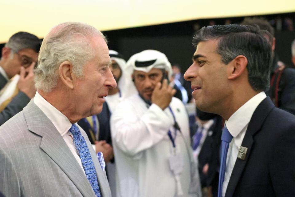 King Charles III speaks with Rishi Sunak at the opening ceremony of the World Climate Action Summit at Cop28 in Dubai (PA)