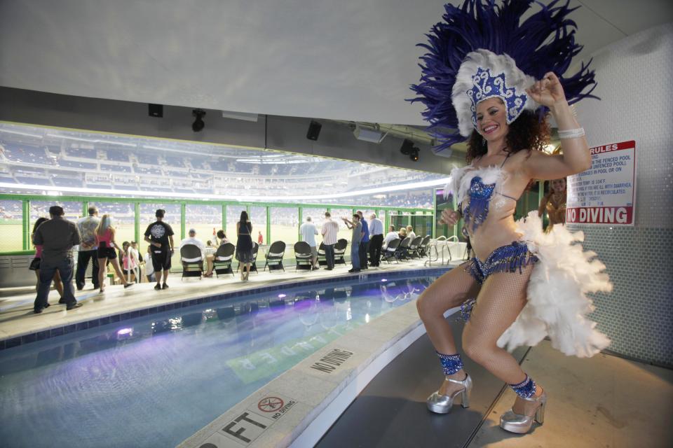 A costumed dancer performs in front of the pool at Marlins Park before the Opening Day baseball game between the Miami Marlins and the St. Louis Cardinals, Wednesday, April 4, 2012, in Miami. (AP Photo/Wilfredo Lee)