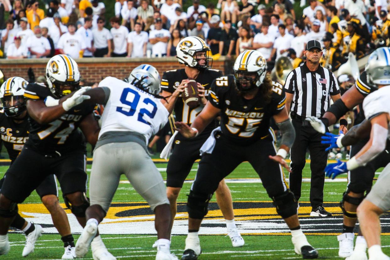 Missouri quarterback Brady Cook scans the defense while hi soffensive line blocks in front of him during a game against Middle Tennessee State at Memorial Stadium on Sept. 9, 2023, in Columbia, Mo.