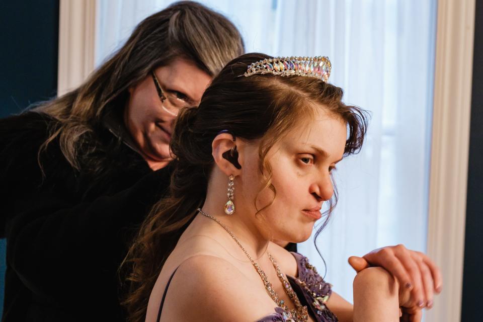 Kaylee Arthurs' mother Kat adjusts her daughter's hair before leaving the Worth family home for a Night to Shine, a prom for people with special needs, on Friday.