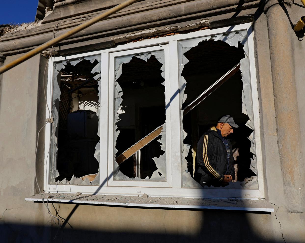 Resident Grigory Samarin, 71, stands inside his house damaged by recent shelling in Donetsk (REUTERS)