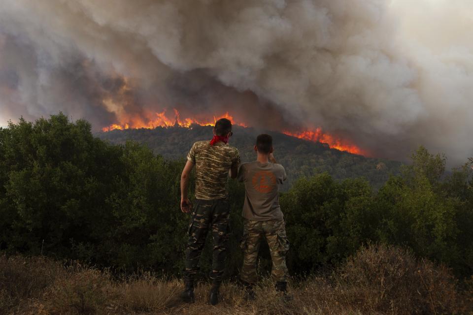 Flames burn a forest during wildfires near the village of Sykorrahi, near Alexandroupolis town, in the northeastern Evros region, Greece, Wednesday, Aug. 23, 2023. Advancing flames are devouring forests and homes in Greece as wildfires that have killed 20 people are raging. (AP Photo/Achilleas Chiras)