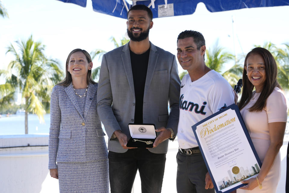 Miami Marlins pitcher Sandy Alcantara, second from left, the 2022 National League Cy Young winner, holds the key to the City of Miami awarded to him by Miami Mayor Francis Suarez, second from right, at Miami City Hall, Tuesday, Jan. 10, 2023, in Miami. At left is Miami Marlins President of Business Operations Caroline O'Connor, and at right is Miami City Commission Chairwoman Christine King. (AP Photo/Lynne Sladky)