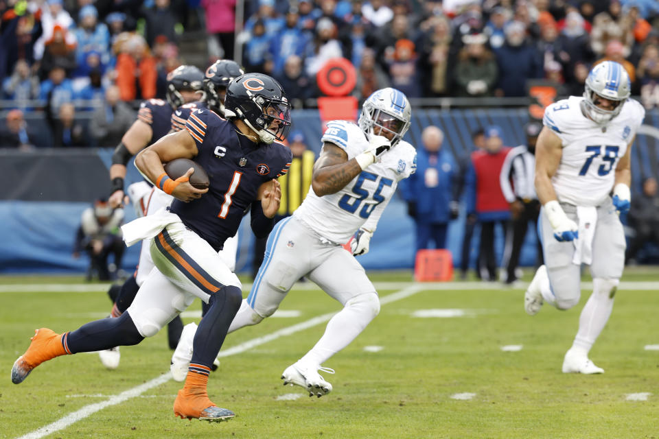 Chicago Bears quarterback Justin Fields (1) runs with the ball against the Detroit Lions during the first half of an NFL football game, Sunday, Dec. 10, 2023, in Chicago. (AP Photo/Kamil Krzaczynski)