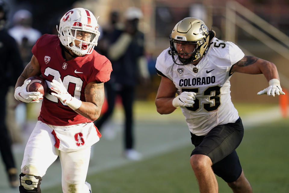 Stanford running back Austin Jones (20) runs against Colorado linebacker Nate Landman (53) during the second half of an NCAA college football game in Stanford, Calif., Saturday, Nov. 14, 2020. (AP Photo/Jeff Chiu)