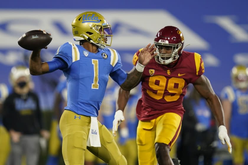 UCLA quarterback Dorian Thompson-Robinson (1) is threatened by Southern California linebacker Drake Jackson (99) during an NCAA football game Saturday, Dec 12, 2020, in Pasadena, Calif. (AP Photo/Ashley Landis)