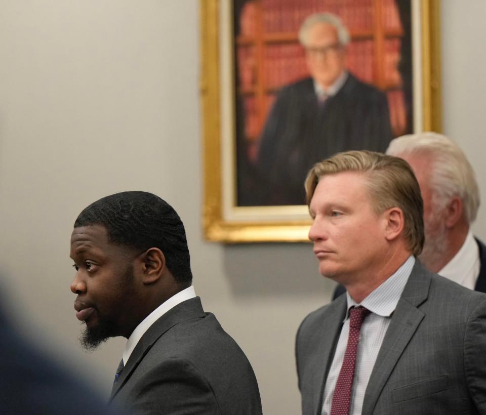 Othal Wallace, left, and his lawyers stand before the judge as his trial for the murder of Daytona Beach Police officer Jason Raynor gets underway in Clay County on Monday, Sept. 11, 2023.