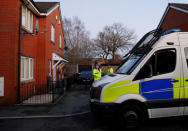 Police officers stand outside a house being searched in connection to a stabbing at Victoria Station in Manchester, Britain, January 1, 2019. REUTERS/Phil Noble