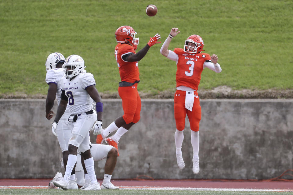 Sam Houston State quarterback Eric Schmid (3) and wide receiver Jequez Ezzard (12) celebrate Schid's touchdown against James Madison during the third quarter of a semifinal game in the NCAA college football FCS playoffs, Saturday, May 8, 2021, in Huntsville, Texas. Sam Houston came from behind to edge James Madison 38-35, for a berth in the FCS national championship game. (Brett Coomer/Houston Chronicle via AP)