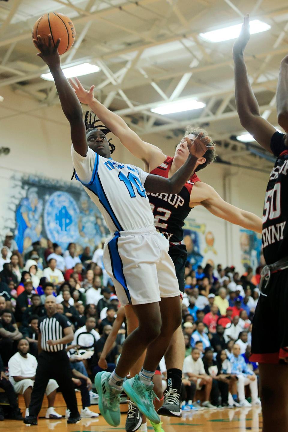 Ribault's Kevin Stokes (10) drives the lane against Bishop Kenny's Max Davis (22) during the third quarter. Ribault won 91-59 to reach the Final Four.