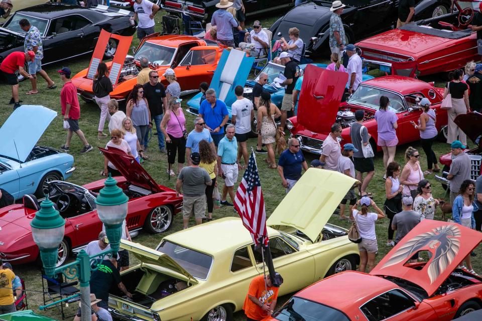 People check out cars during the Muscle on the Beach Car Show at Old School Square in Delray Beach on Saturday.