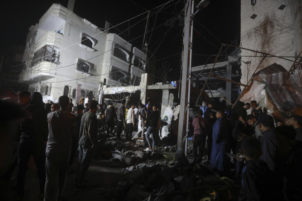 Palestinians inspect the rubble of destroyed buildings of the Abo al Hanood family after an Israeli airstrike in Rafah refugee camp, southern Gaza Strip, Wednesday, April 17, 2024. Palestinian medics said several residents, including children, were killed in the airstrike. (AP Photo/Ismael Abu Dayyah)