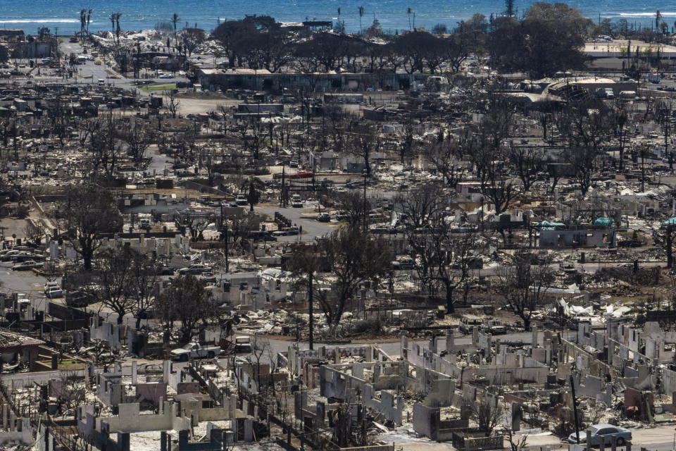 FILE - Charred remains of homes are visible following a wildfire in Lahaina, Hawaii, Aug. 22, 2023. When the winds of Hurricane Dora lashed Maui Aug. 8, they struck bare electrical lines the Hawaiian electric utility had left exposed to the elements. (AP Photo/Jae C. Hong, File)