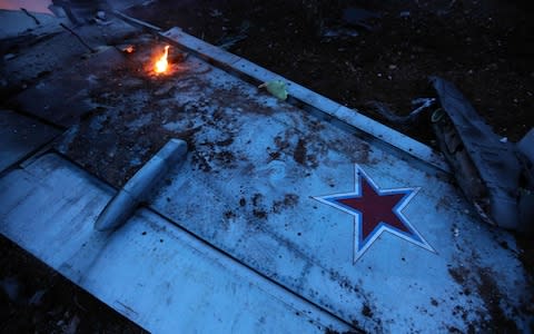 The wing of a downed Sukhoi-25 fighter jet in Syria's northwest province of Idlib - Credit: AFP