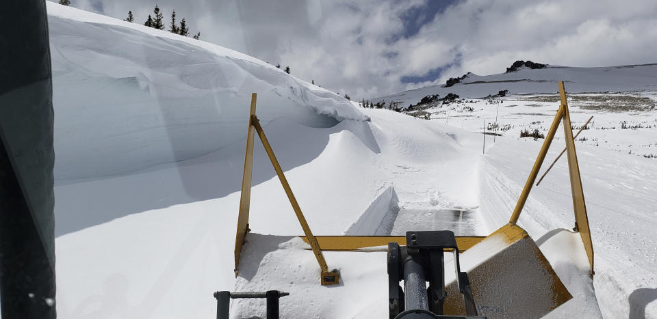 This May 1, 2019, photo provided by the National Park Service shows a snowplow clearing a 19-foot drift on Trail Ridge Road in Rocky Mountain National Park, Colo. This section of the road had been cleared previously but a spring storm dropped more snow, requiring crews to plow it again. Heavy winter snow and a cold, wet May in the Rocky Mountains are sending a welcome surge of spring runoff into the rivers of the Southwestern U.S., fending off a water shortage but threatening to push some streams over their banks. (National Park Service via AP)