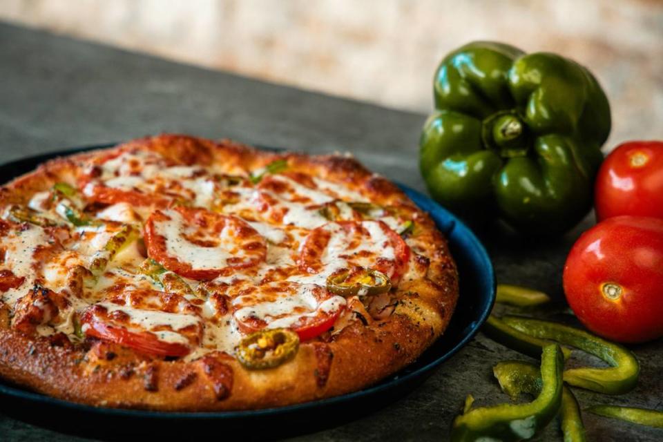 PARLOUR, an Indiana-based pizza chain, has a menu of craft pizza options including “The Dr,” with an olive oil base, sliced provolone, shredded mozzarella, sliced green peppers, sliced red onions, smoked chicken bacon, jalapenos, sliced roma tomatoes and house-made peppercorn ranch drizzle.