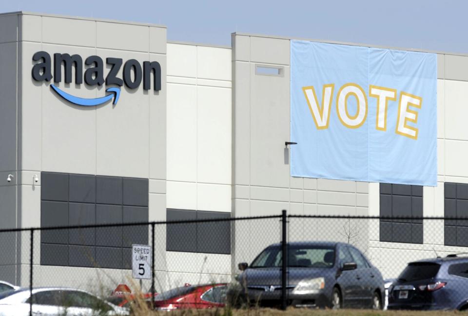 In this March 30, 2021, file photo, a banner encouraging workers to vote in labor balloting is shown at an Amazon warehouse in Bessemer, Ala. Following a string of union victories at Amazon and Starbucks, a group of prominent progressive grantmakers is seeking to put a total of $20 million into a coalition with organized labor that will steer funds to organizing and advocacy campaigns in the South.