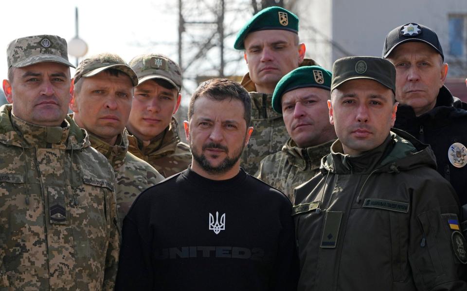 Ukrainian President Volodymyr Zelensky poses for a photo with military personnel and police officers during a visit to Trostianets - Efrem Lukatsky/AP