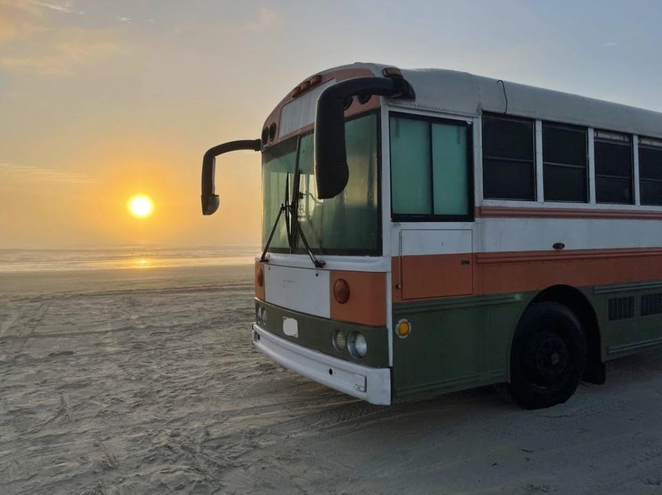 renovated school bus with sun in the background