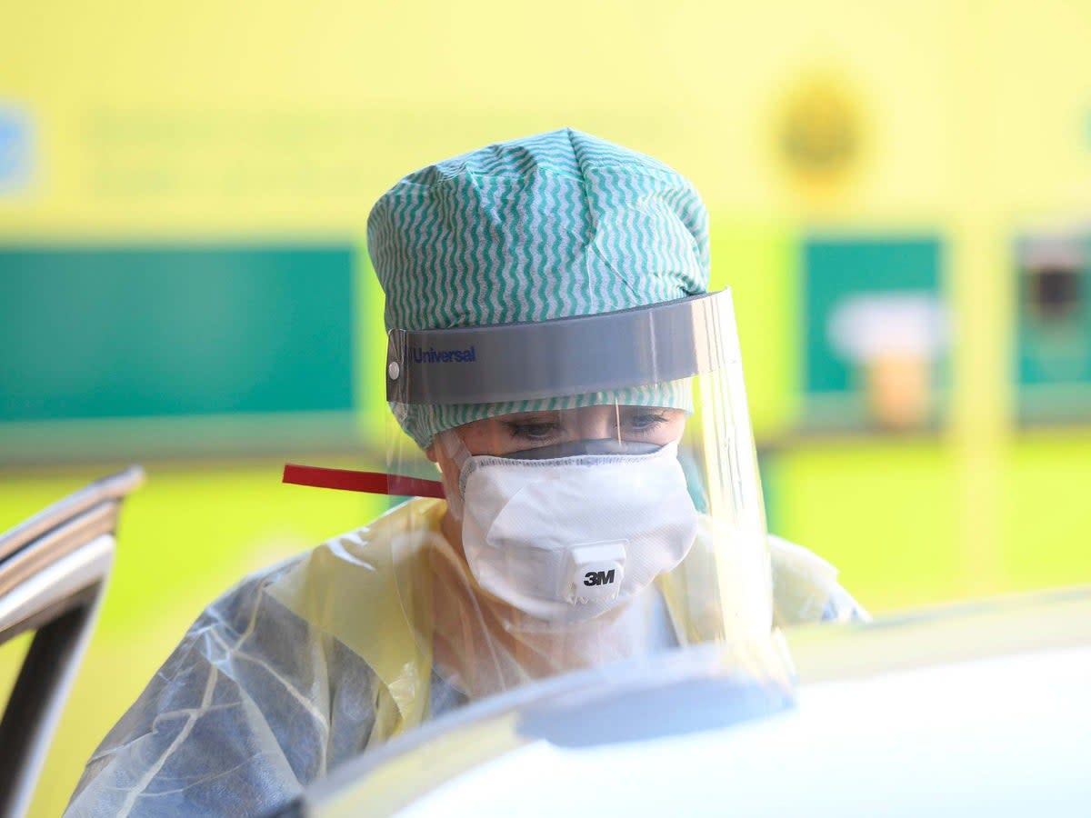 An A&E nurse wearing full protective equipment in the early months of the pandemic (PA)