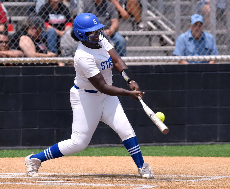 With the bat bending slightly from the impact before snapping back, Stamford’s Trinity Johnson hits the ball low into the Colorado City infield.