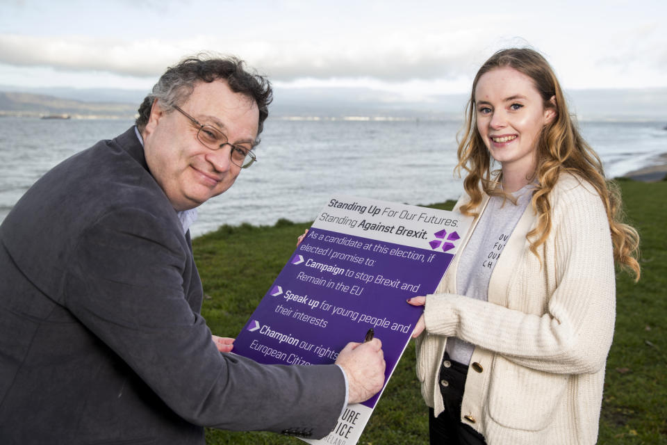 Alliance candidate for North Down Stephen Farry signing a pledge to stop Brexit with Doire Finn from Our Future Our Choice (Liam McBurney/PA)