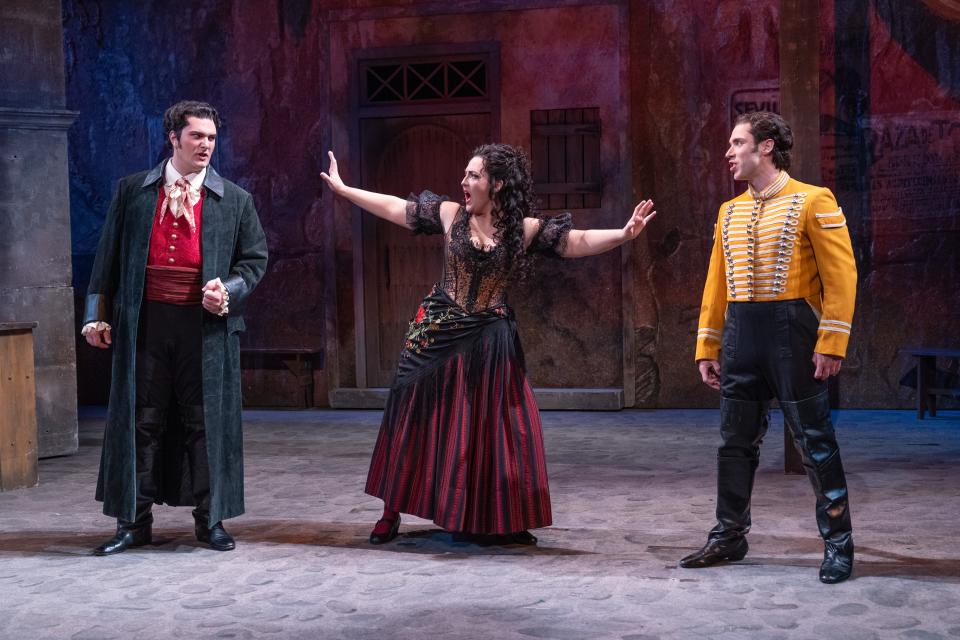 Chelsea Maggan, center, as Carmen, tries to keep apart the toreador she loves, Escamillo (played by Andrew Manea), left, and the soldier, Don José (Victor Starsk), she has toyed with in the Sarasota Opera production of Georges Bizet’s “Carmen.”