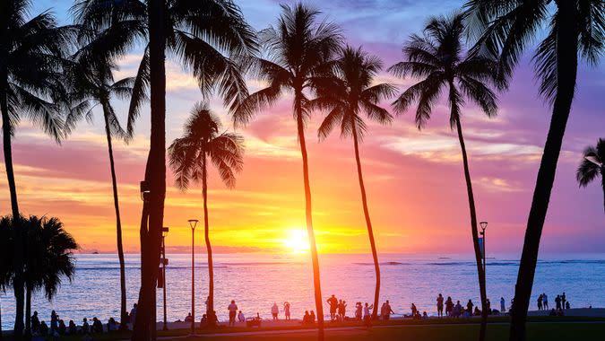 Hawaii's Kauai and palm trees in dramatic sky at Sunset