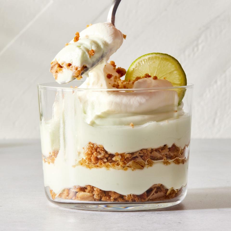 layered key lime pie mousse with whipped cream and a lime