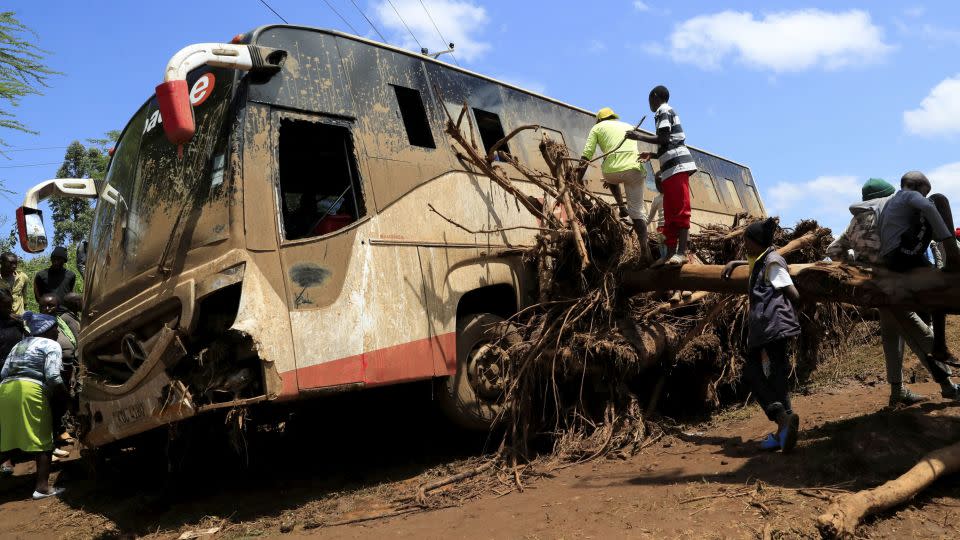 A damaged passenger bus stuck on a fallen tree after heavy flash floods wiped out several homes when a dam burst, following heavy rains in Kamuchiri village of Mai Mahiu, Nakuru County, Kenya, on April 29. - Thomas Mukoya/Reuters