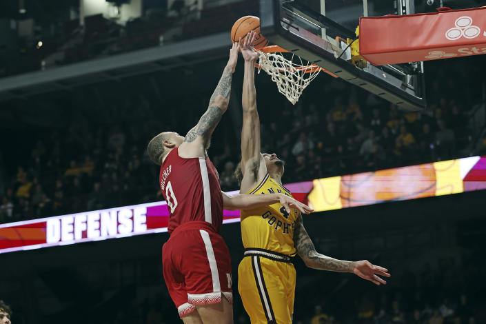 Nebraska guard C.J. Wilcher (0) makes a basket against Minnesota guard Braeden Carrington (4) during the second half of an NCAA college basketball game Saturday, Jan. 7, 2023, in Minneapolis. Nebraska won 81-79 in overtime. (AP Photo/Stacy Bengs)