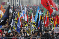 People hold various banners and flags during a rally to support political prisoners in Moscow, Russia, Sunday, Sept. 29, 2019. (AP Photo/Dmitri Lovetsky)