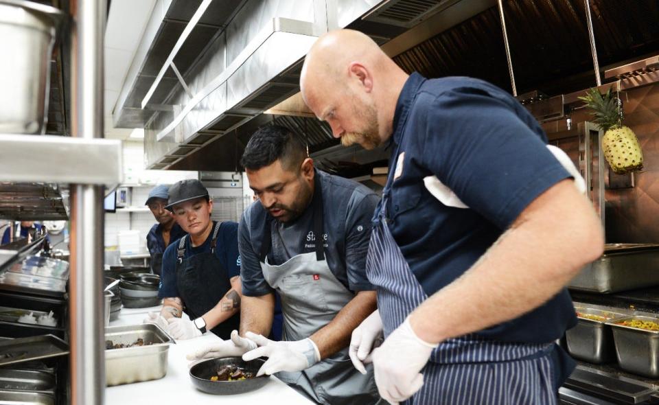 Chefs Rick Mace (right) and Pushkar Marathe collaborate on a dish during the James Beard Award semifinals lunch at Stage Kitchen in Palm Beach Gardens on March 6.