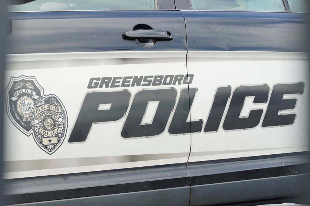 A cruiser sits in a parking lot outside police headquarters in Greensboro, N.C., on Wednesday, June 22, 2022. The city decided to let lapse its contract with Fog Reveal, a powerful phone-tracking tool that some advocates fear violates people’s privacy rights. (AP Photo/Allen G. Breed)